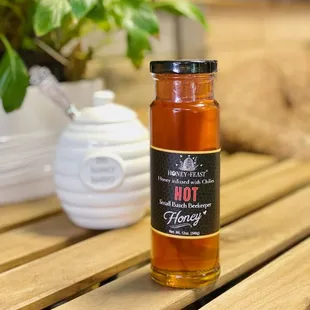 a jar of honey on a wooden table