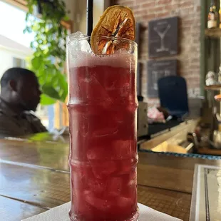 a tall glass of red drink