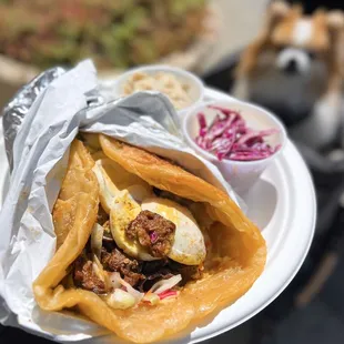 Ma&apos;lawah Sabich w/ sliced hard boiled egg, roasted eggplant, hummus, cabbage, schug, tahini, amba sauce | $20 (vegetarian)