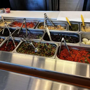 Bar teeming with salads and accompaniments