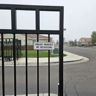 It's hard to read the sign when the "almost security" gate is broken. I don't think it's stopping anyone today.