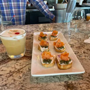 The best whiskey sour on earth with salmon cookies for happy hour which is 4-7pm