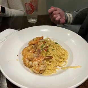 a plate of pasta with shrimp