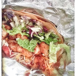 Fish taco with fresh blackened catch, cabbage, refried beans, house made salsa, cheese, and house dressing