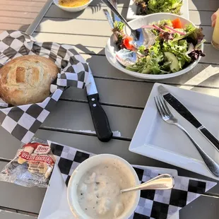 Clam Chowder was excellent and entree included house bread loaf with oil dipping sauce and house salad family style.