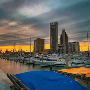 boats docked in a harbor at sunset