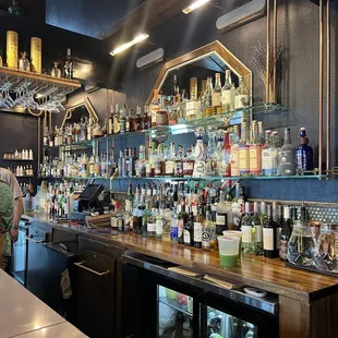 a bar with many bottles of alcohol