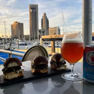 three sliders and a beer on a table