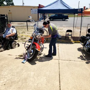 a man standing next to a parked motorcycle