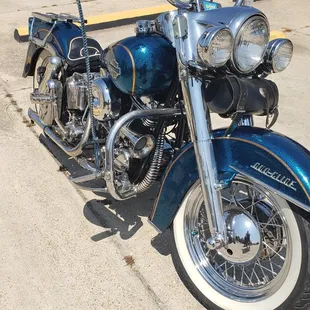 a blue motorcycle parked on the side of the road