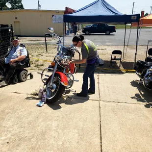 a man working on a motorcycle