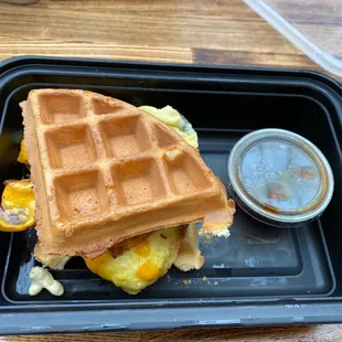 a waffle sandwich on a plastic tray