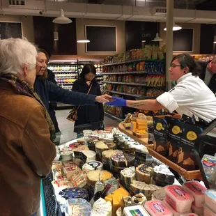 Our cheese lady doing tastings of amazing cheeses from around the world!
