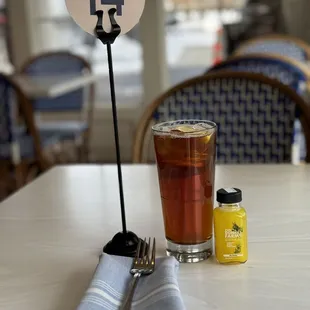 a glass of tea and a fork