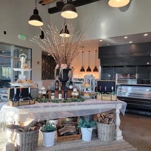 Entrance with a few tables to the side and the pizza oven in the background.