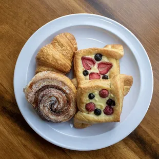 Freshly baked croissants, cinnamon and sugar twist pastries, and cheese and fruit danishes.