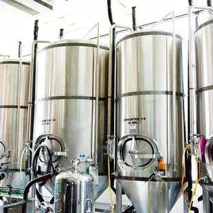 a row of stainless steel tanks