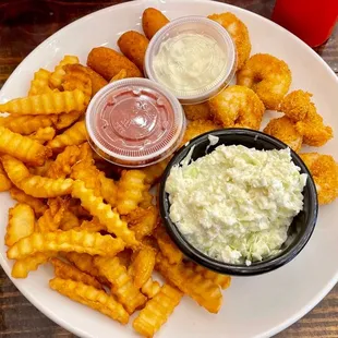 Fried shrimp with fries, hushpuppies, and slaw.