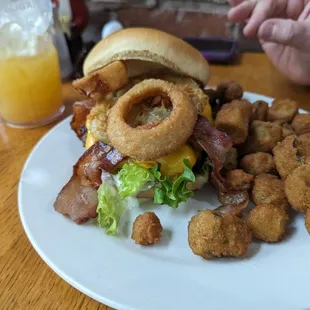 Destiny&apos;s Burger - Burger topped with fried green tomatoes, cheddar cheese, onion rings, bacon, lettuce and a homemade ranch dressing.