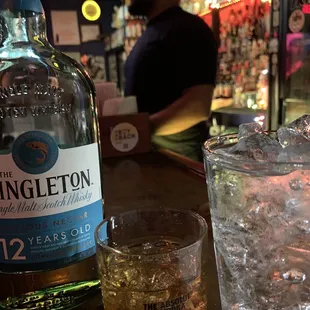 a glass of gingleton next to a bottle of gingleton
