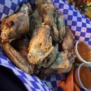 a basket of fried food with dipping sauce