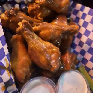 a basket of chicken wings and beer