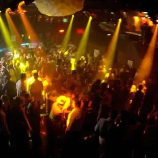 a crowd of people dancing at a nightclub