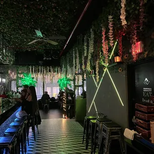 a long bar with tables and chairs