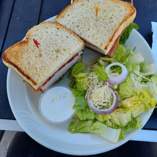 Cali Clubhouse sandwich. Loaded high with ham, turkey, lettuce, tomato, bacon and avocado on sourdough.  Really good!
