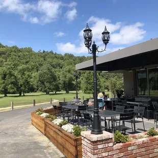 a patio with tables and chairs