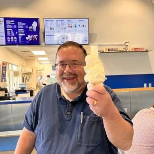 a man holding a cone of ice cream