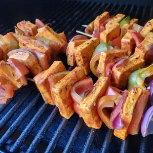 skewered vegetables on a grill