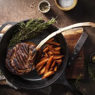a steak and fries in a skillet