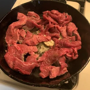 a frying pan filled with meat