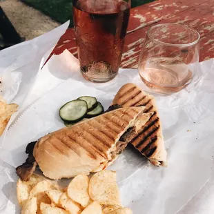 a grilled sandwich and chips