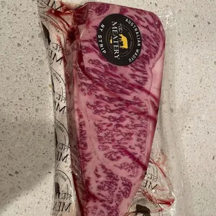 a piece of meat wrapped in plastic