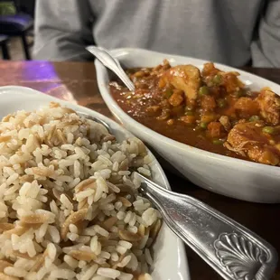 a plate of rice and a bowl of stew