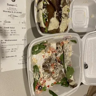 A $9 small salad compared to an $11 large salad. To add gyro meat is the same 4.50 flat fee. Receipt is visible for pricing.