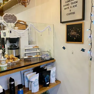 a coffee shop counter with a variety of coffees