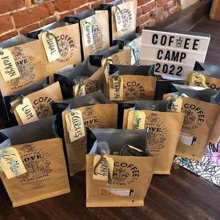 coffee bags with coffee camp stickers on them