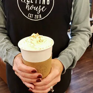a woman holding a cup of coffee