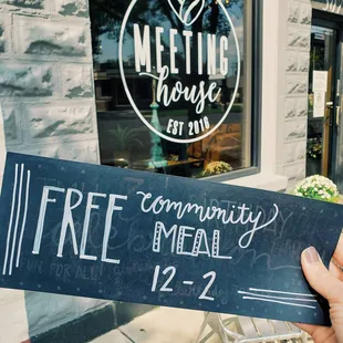 a person holding up a sign