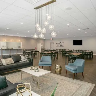 Seating area includes 9 six-foot tables, 48 chairs, couch and lounge area.