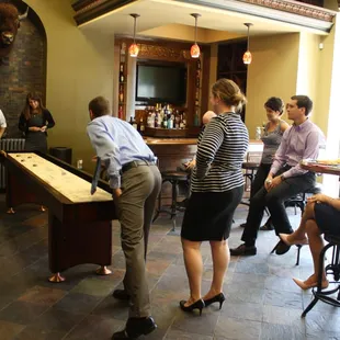 A shuffleboard table adds an element of fun to The Meeting Spot's casual pub area.