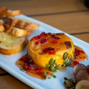 Four Cheese Spread. Signature MTG Dish, blend of four creamy cheeses, topped with made from scratch red pepper jelly.