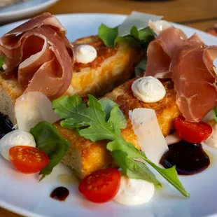 Crostone. Toasted focaccia bread, whipped ricotta, tomato puree, fresh prociutto and aged balsamic vinegar. and local extra virgin olive oil
