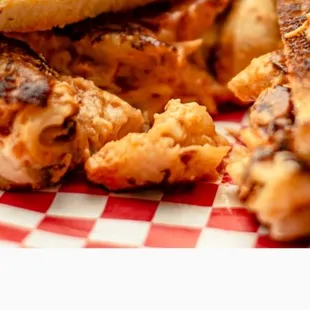 Buffalo Mac Melt our creamy buffalo chicken mixed with our mac-n-cheese grilled on garlic dill Texas toast