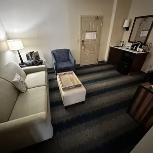 Front separate room with mini fridge and TV in a standard room