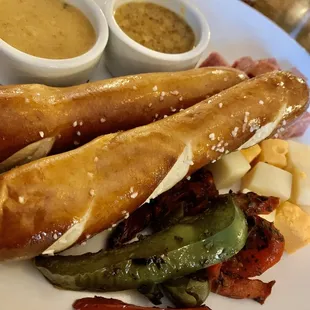 Great Happy Hour pretzel plate with meats, cheeses and roasted garlic peppers!