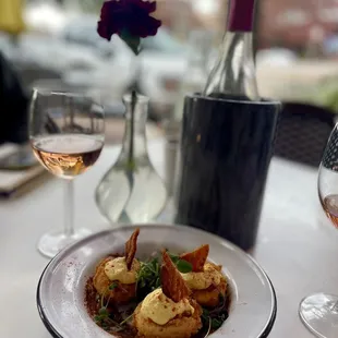 a plate of food and a glass of wine